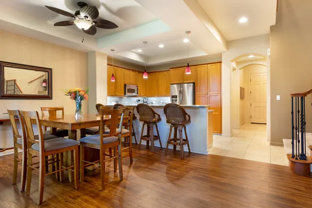 a view of a a dining room with furniture window and wooden floor