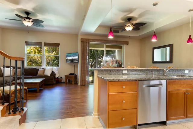a living room with granite countertop kitchen island furniture and a chandelier