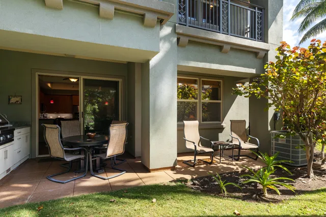 a view of a house with backyard porch and sitting area