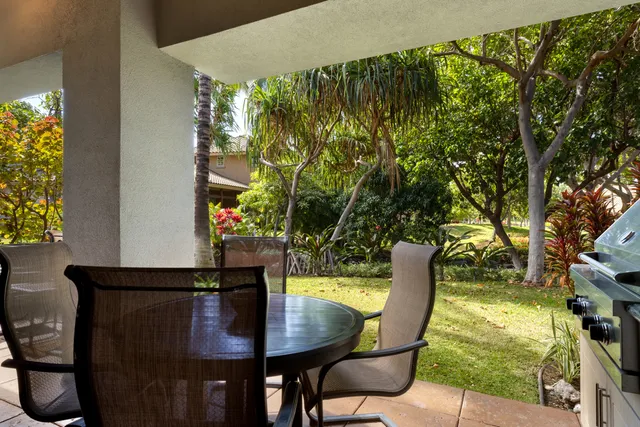 a view of a chairs and table in patio