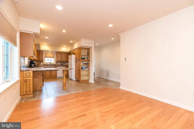 a view of kitchen with kitchen island a sink a stove and a refrigerator