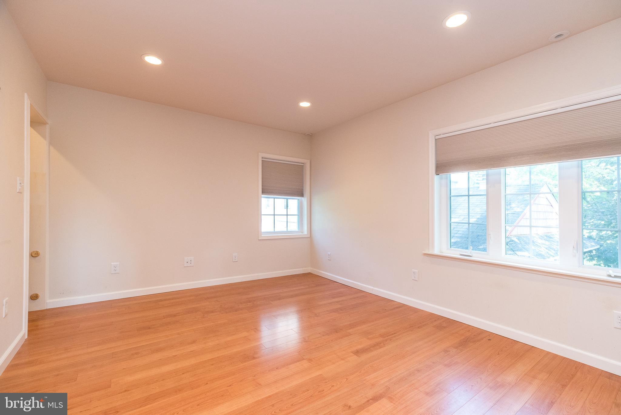 2478 River Road, Unit CARRIAGE New Hope, PA 18938 - Photo 9 of 23 an empty room with wooden floor and windows