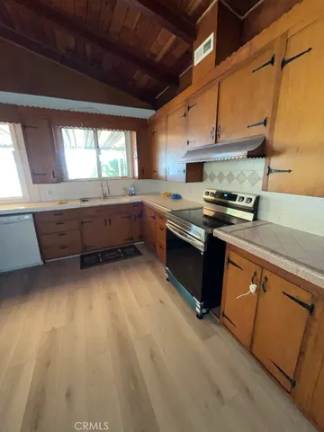 a kitchen with wooden cabinets and a sink