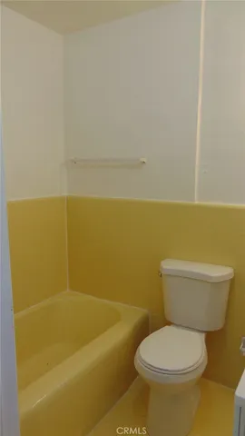 a white toilet sitting next to a bathroom sink