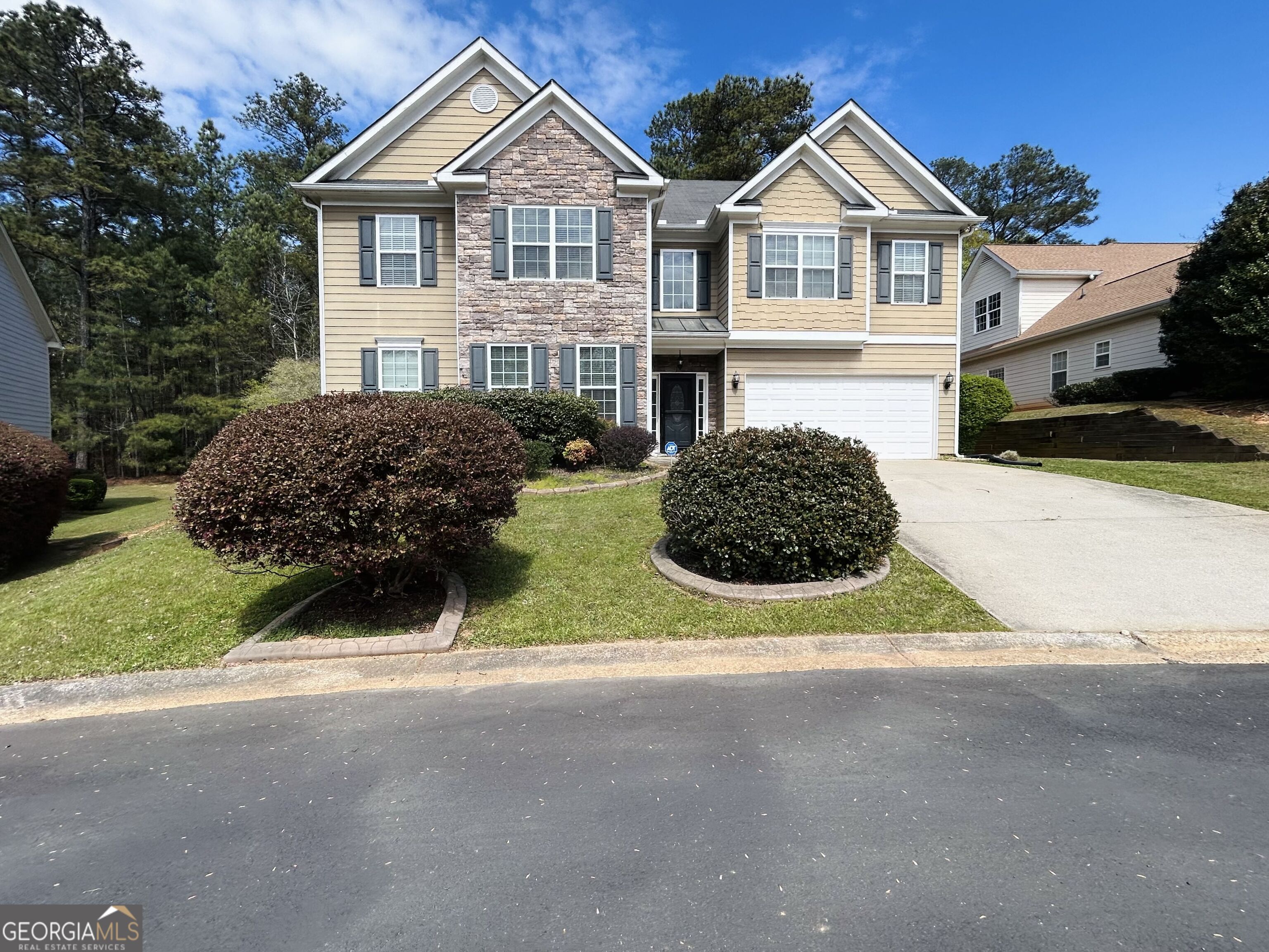 a view of house with outdoor space and parking