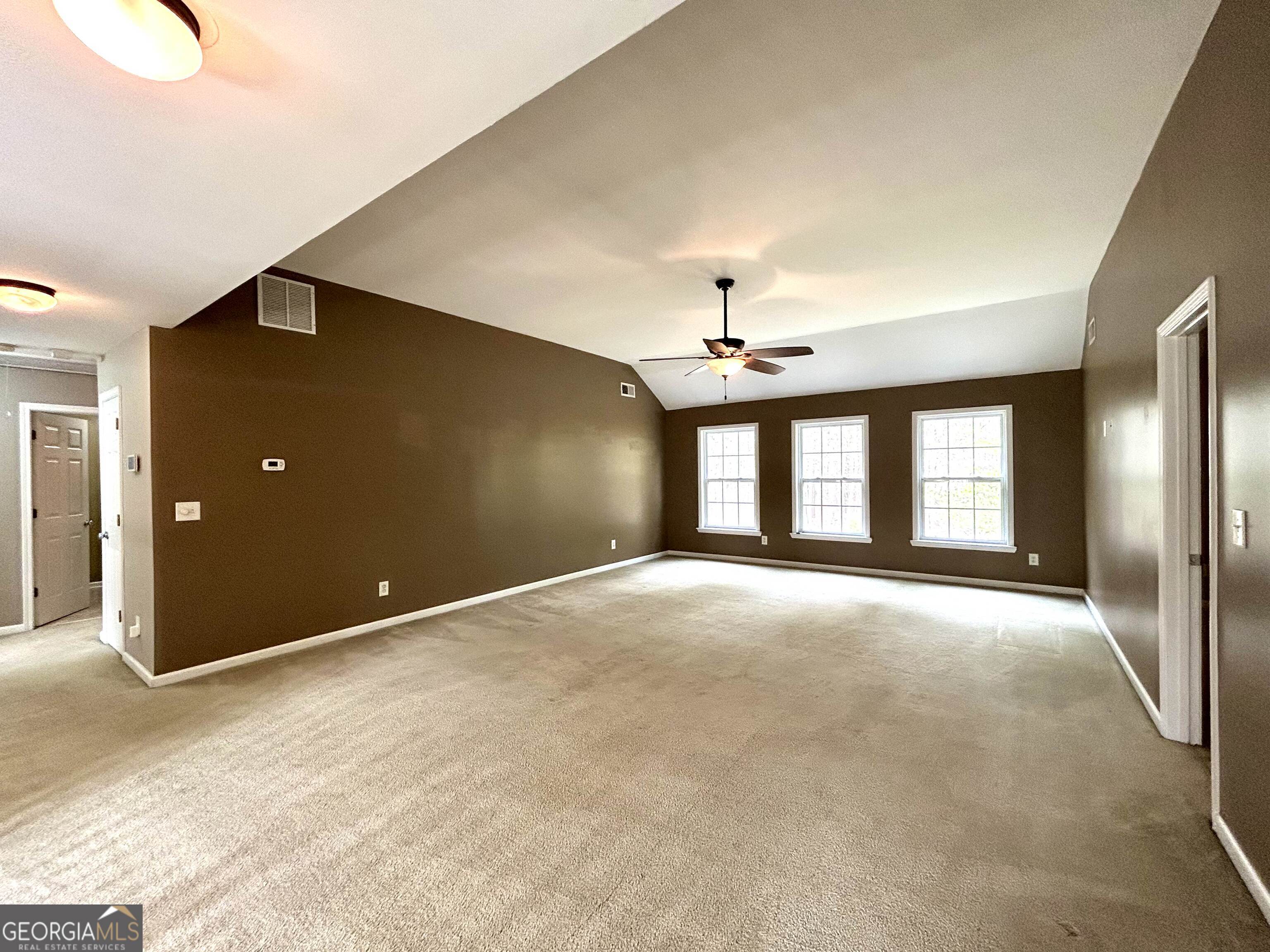 7613 Cedar Grove Court Fairburn, GA 30213 - Photo 14 of 61 a view of an empty room with chandelier fan and window