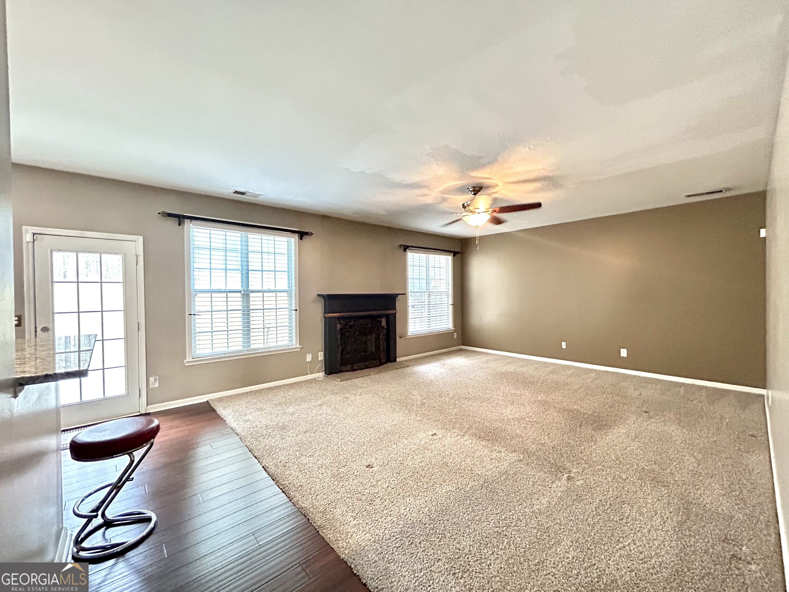 7613 Cedar Grove Court Fairburn, GA 30213 - Photo 17 of 61 an empty room with windows and fireplace
