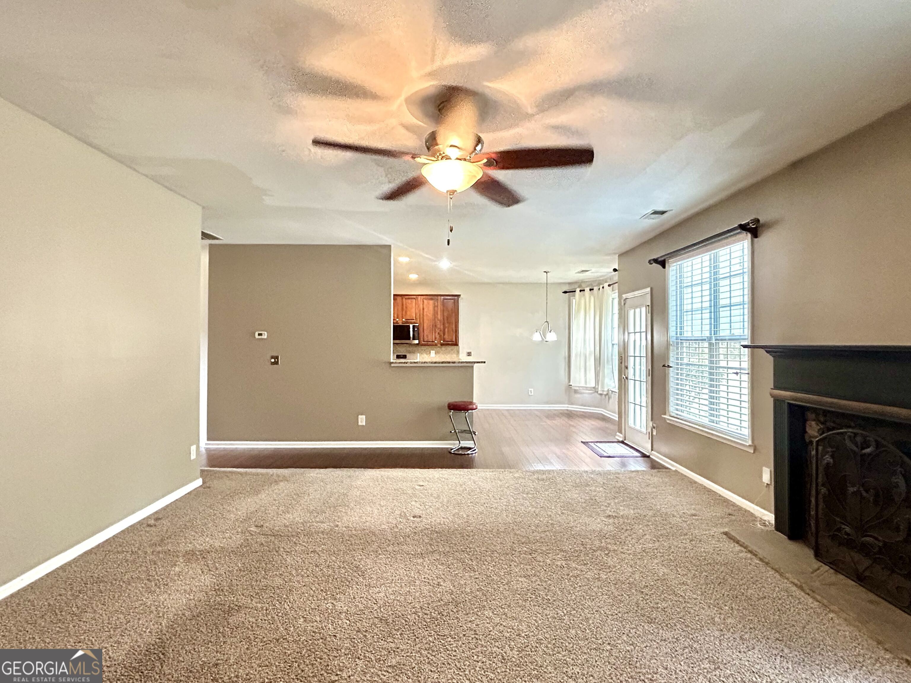 7613 Cedar Grove Court Fairburn, GA 30213 - Photo 21 of 61 a view of a livingroom with a fireplace and a ceiling fan