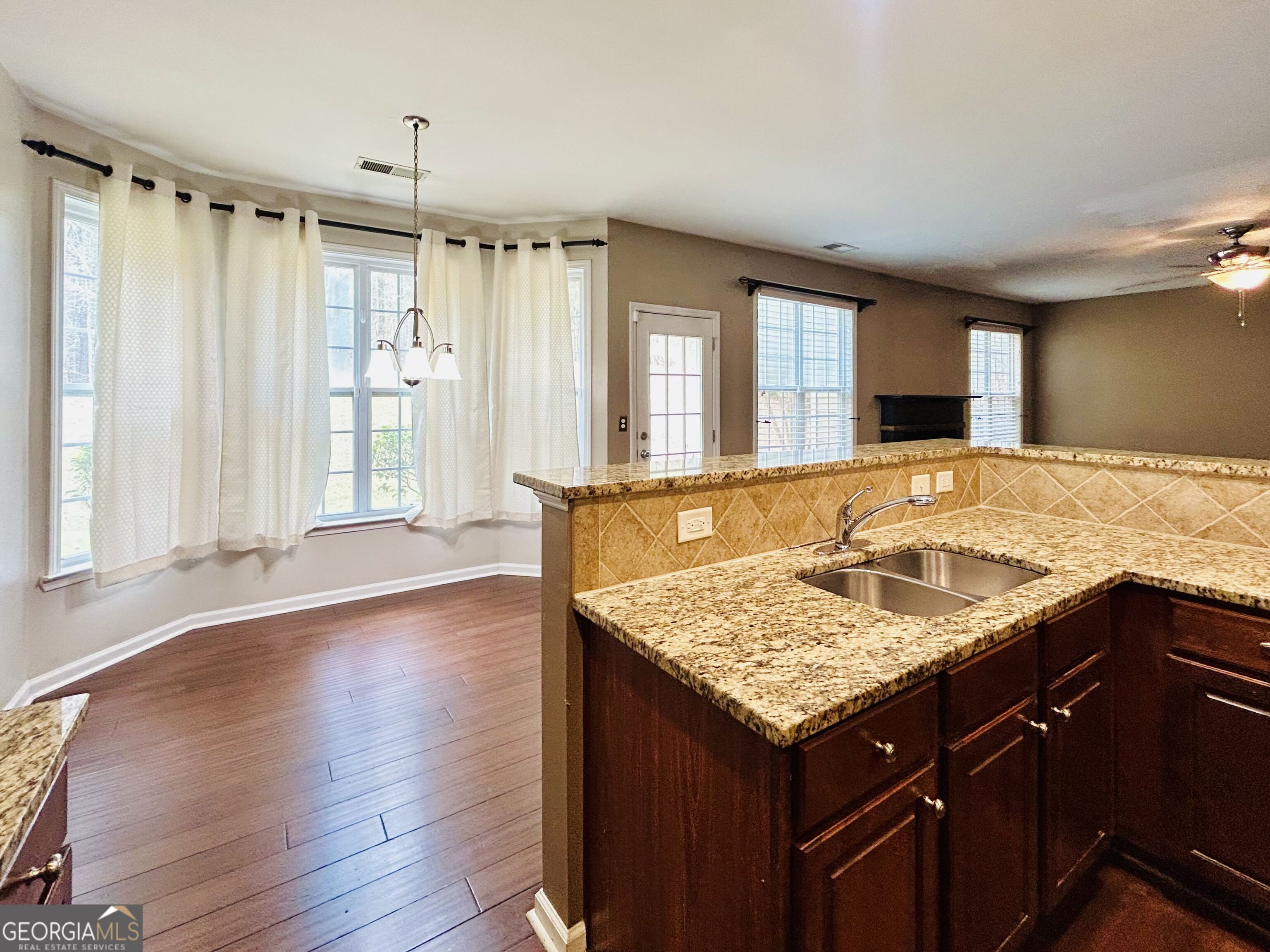 7613 Cedar Grove Court Fairburn, GA 30213 - Photo 23 of 61 a bathroom with a granite countertop sink and a large mirror