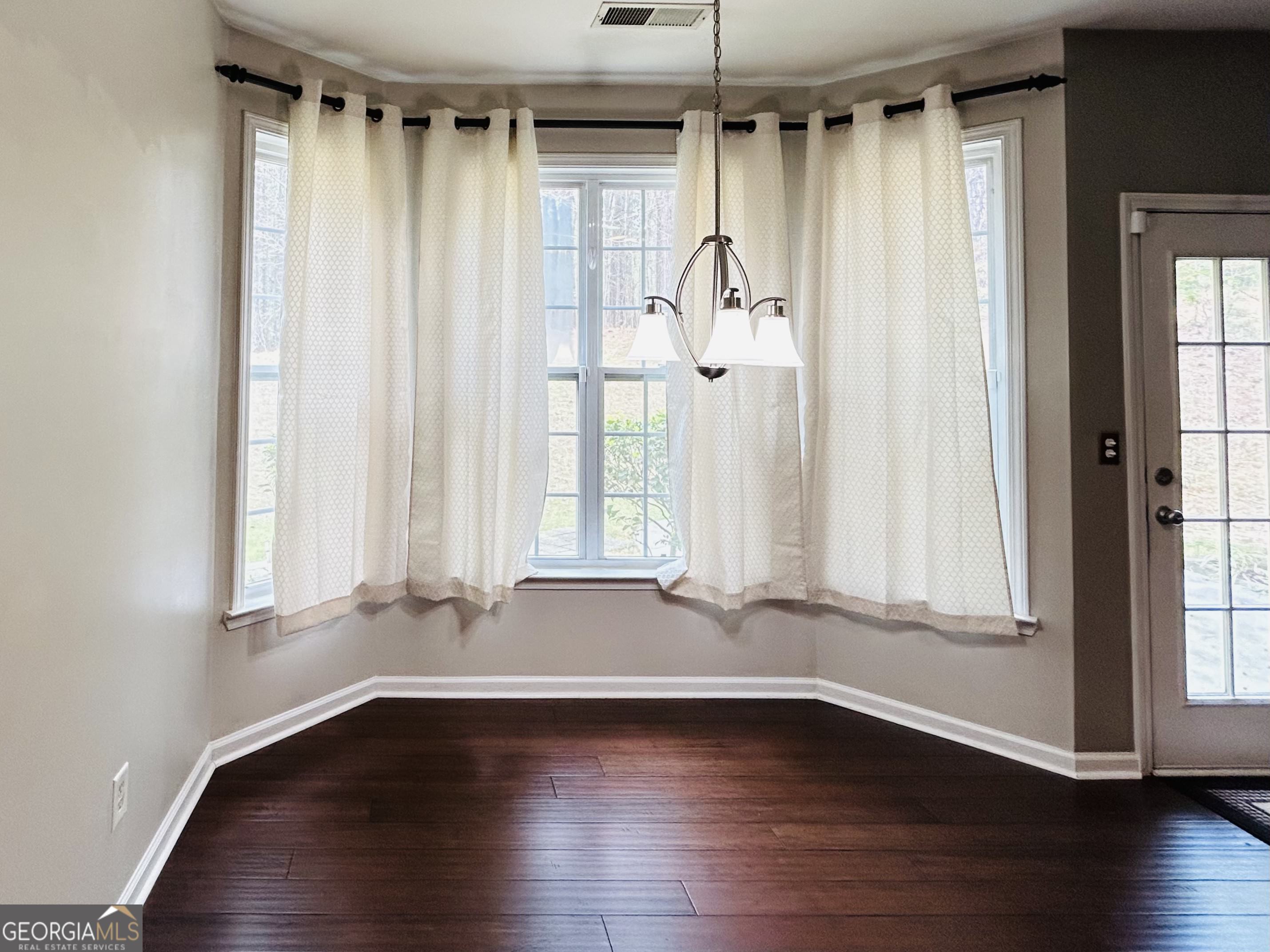 7613 Cedar Grove Court Fairburn, GA 30213 - Photo 24 of 61 a view of an empty room with wooden floor and a window