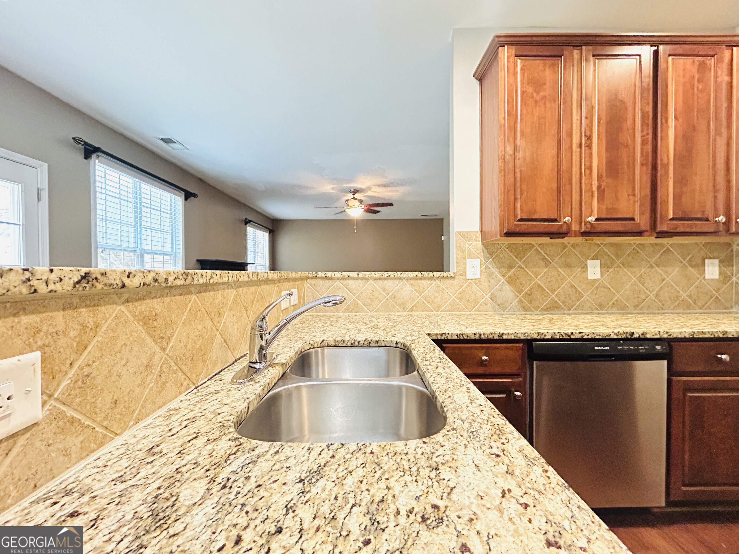 7613 Cedar Grove Court Fairburn, GA 30213 - Photo 25 of 61 a kitchen with a sink cabinets and a large window