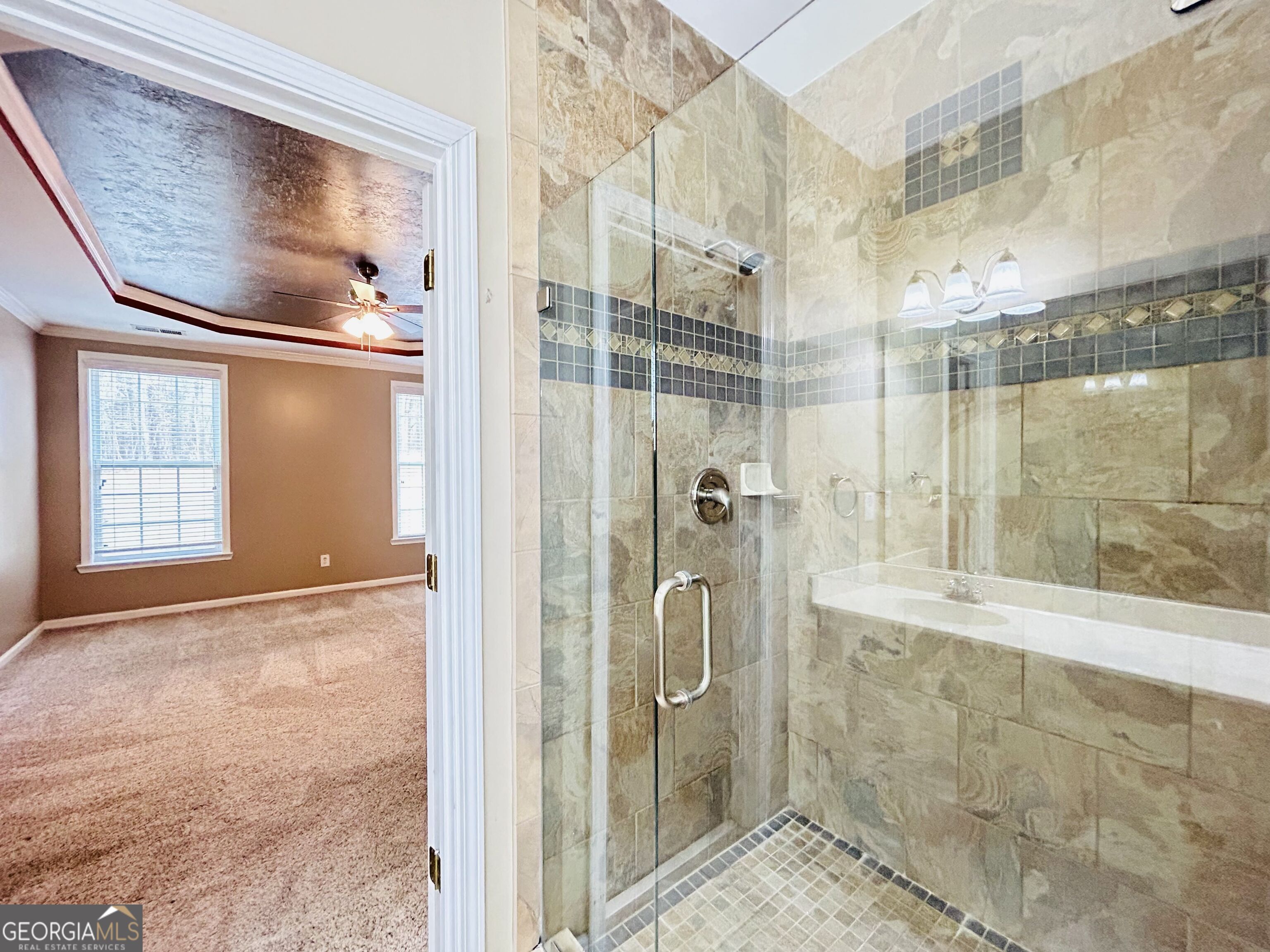 7613 Cedar Grove Court Fairburn, GA 30213 - Photo 38 of 61 a bathroom with a glass shower door