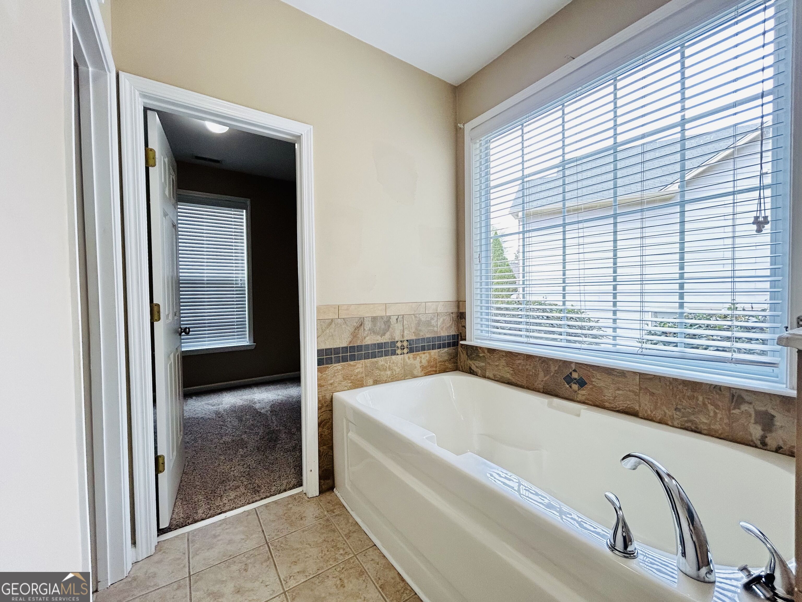 7613 Cedar Grove Court Fairburn, GA 30213 - Photo 39 of 61 a bathroom with bathtub and window