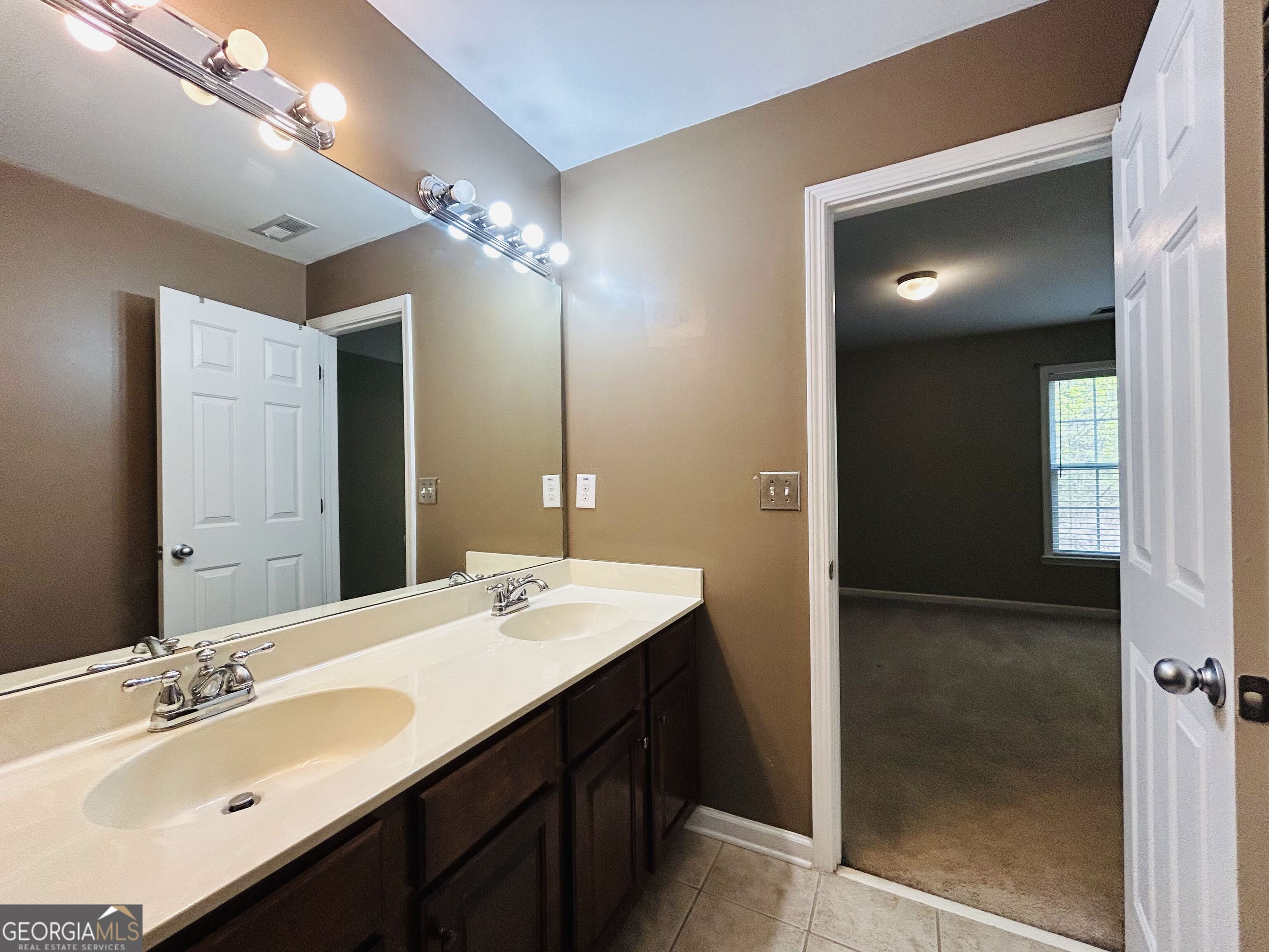 7613 Cedar Grove Court Fairburn, GA 30213 - Photo 44 of 61 a bathroom with a sink double vanity and a mirror