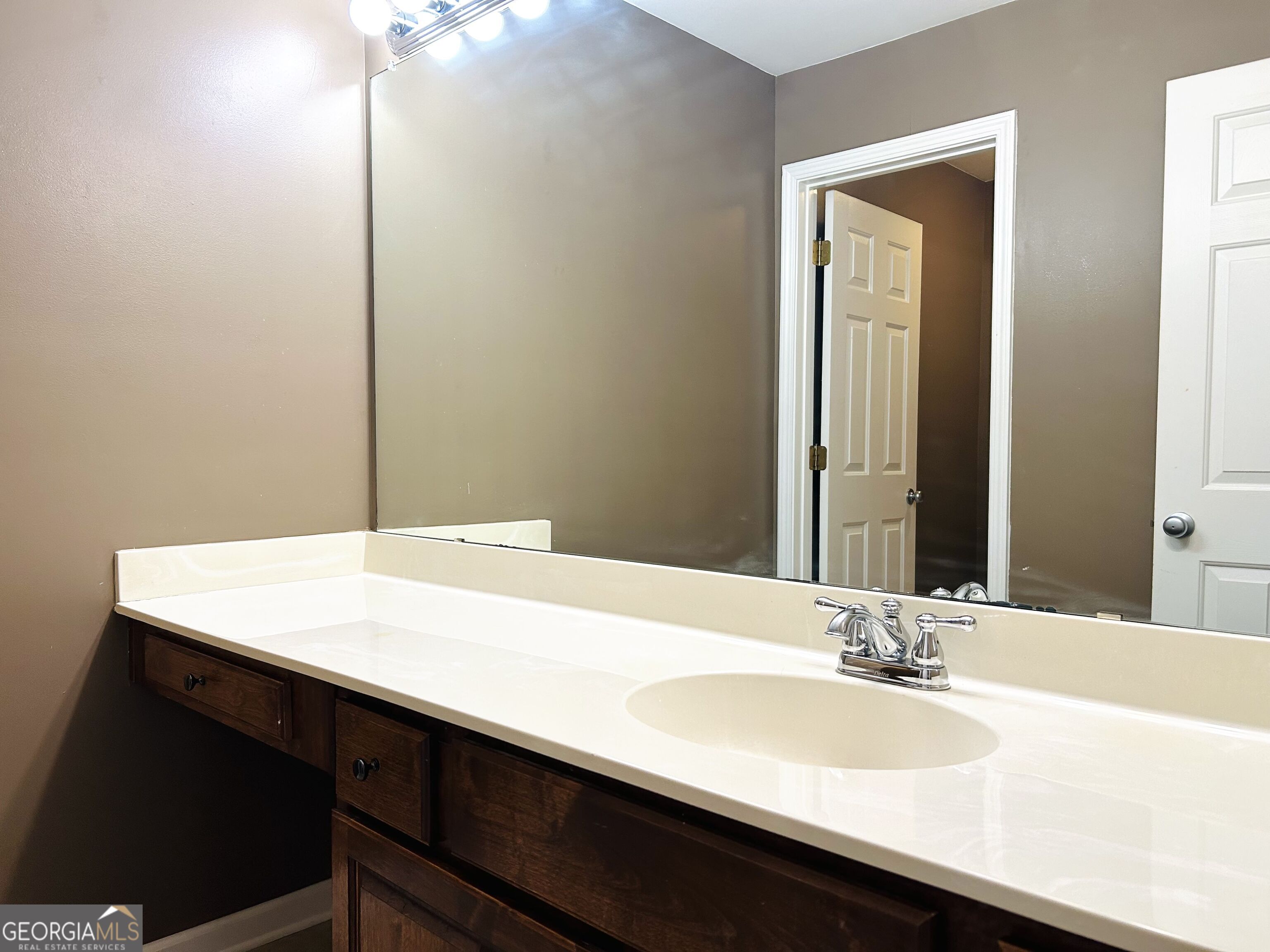 7613 Cedar Grove Court Fairburn, GA 30213 - Photo 47 of 61 a bathroom with a sink a vanity and a mirror