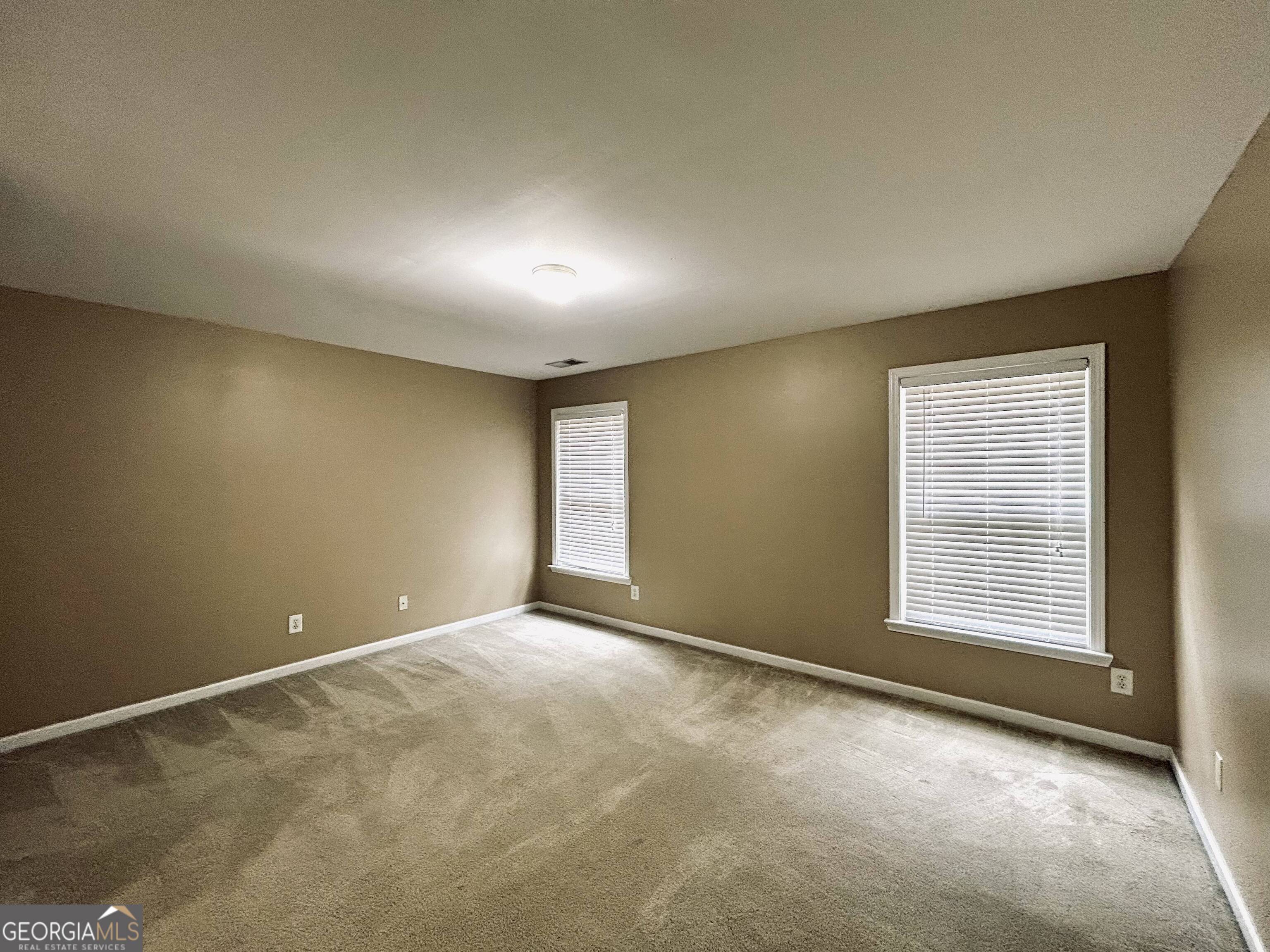 7613 Cedar Grove Court Fairburn, GA 30213 - Photo 50 of 61 an empty room with windows