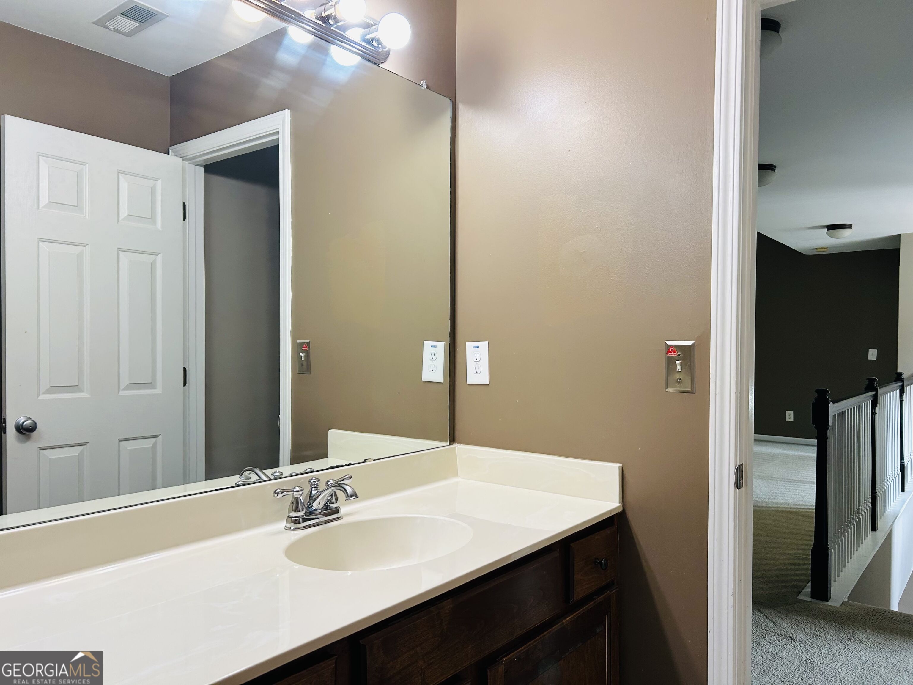 7613 Cedar Grove Court Fairburn, GA 30213 - Photo 55 of 61 a bathroom with a sink and a mirror