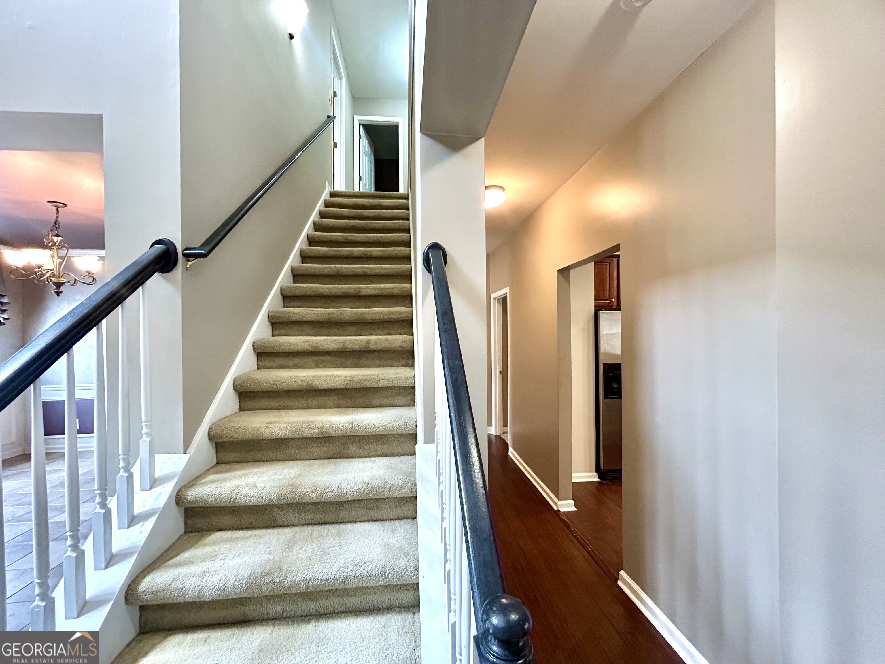 7613 Cedar Grove Court Fairburn, GA 30213 - Photo 10 of 61 a view of staircase with lots of frames on wall and windows