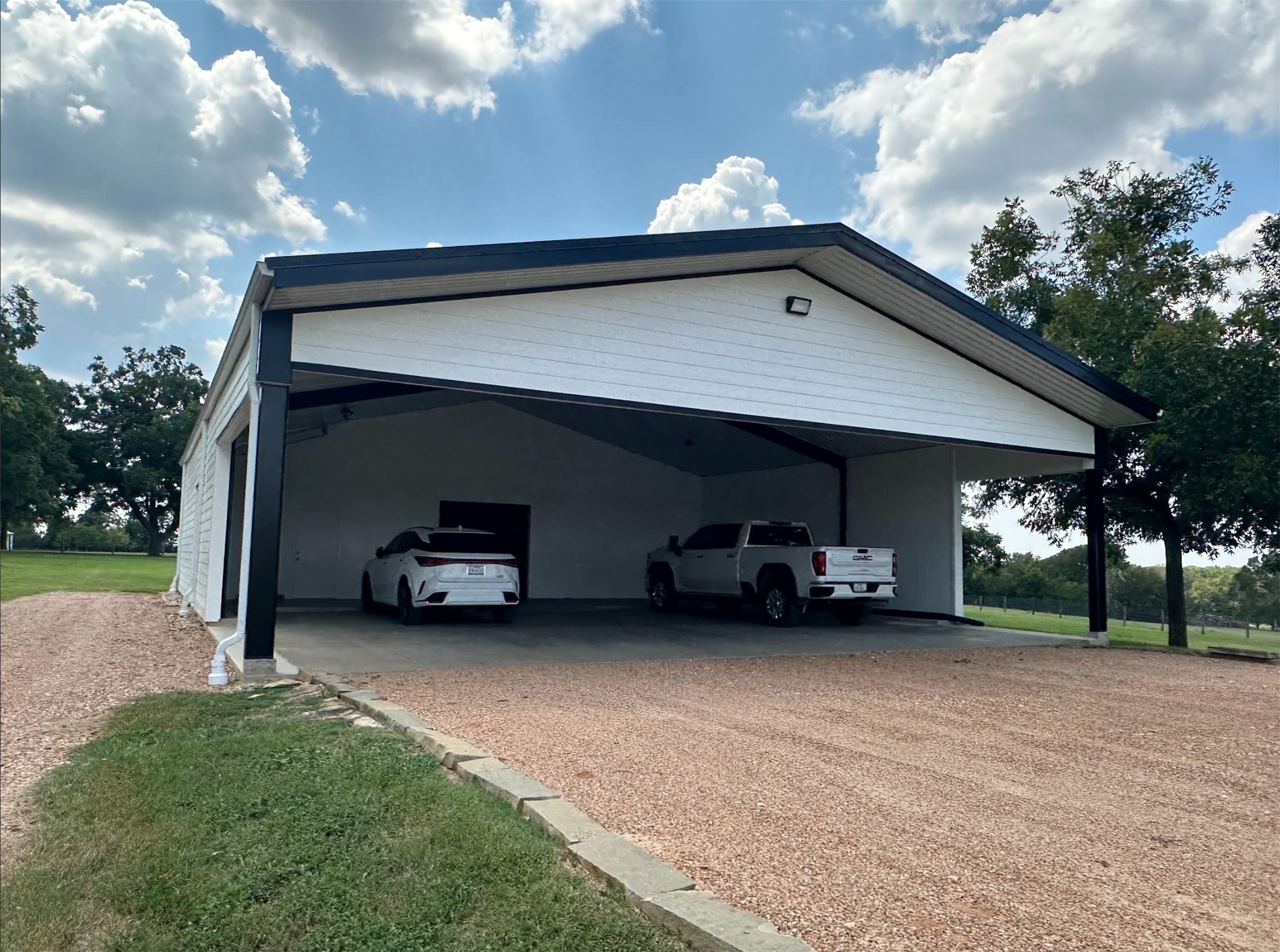 1325 Stalmach Road New Ulm, TX 78950 - Photo 12 of 50 Barn-style carport with attached workshop & one roll-up garage door.