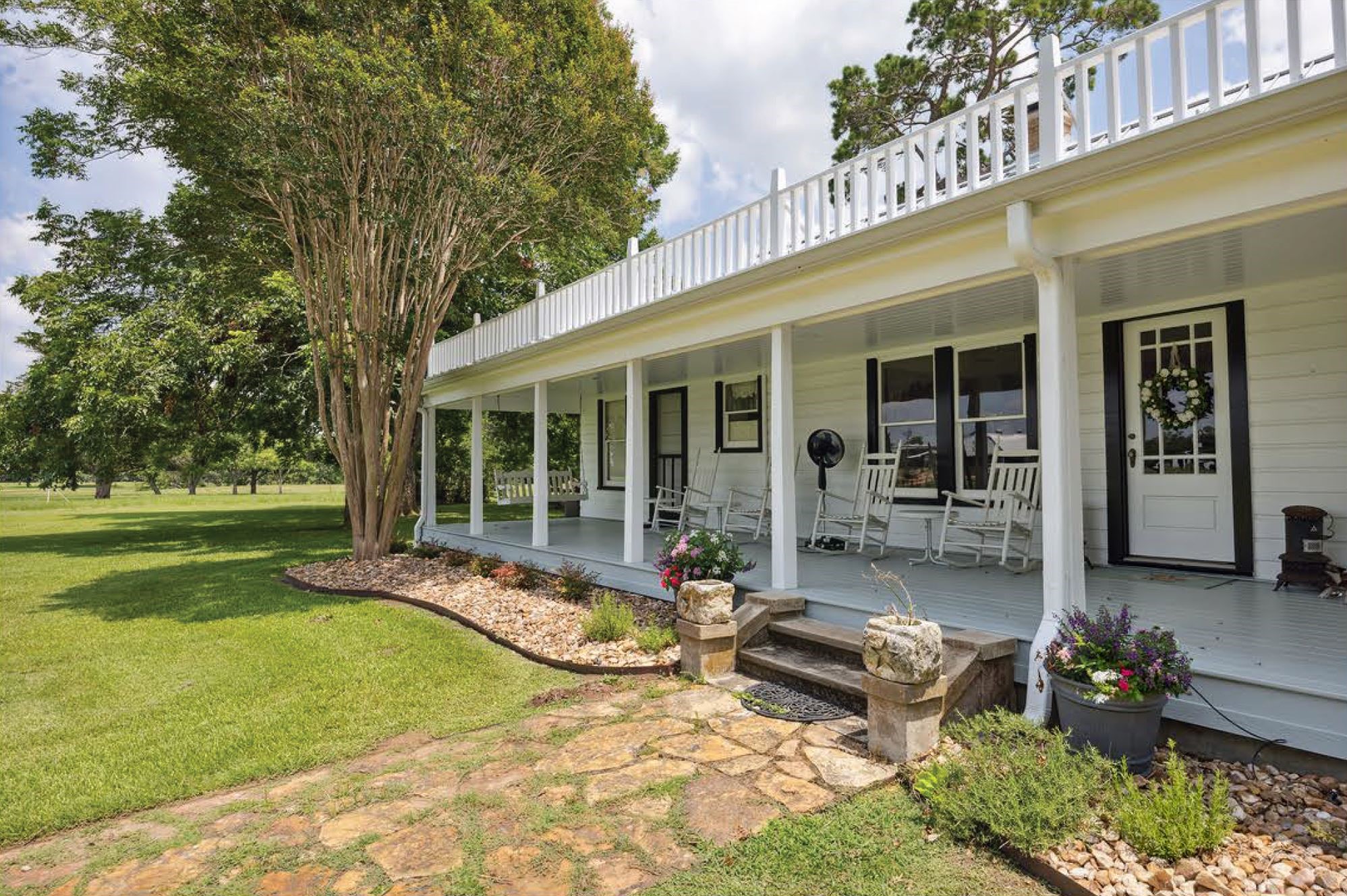 1325 Stalmach Road New Ulm, TX 78950 - Photo 30 of 50 Large, flagstone walkway leading to covered front porch spanning the front of main house.