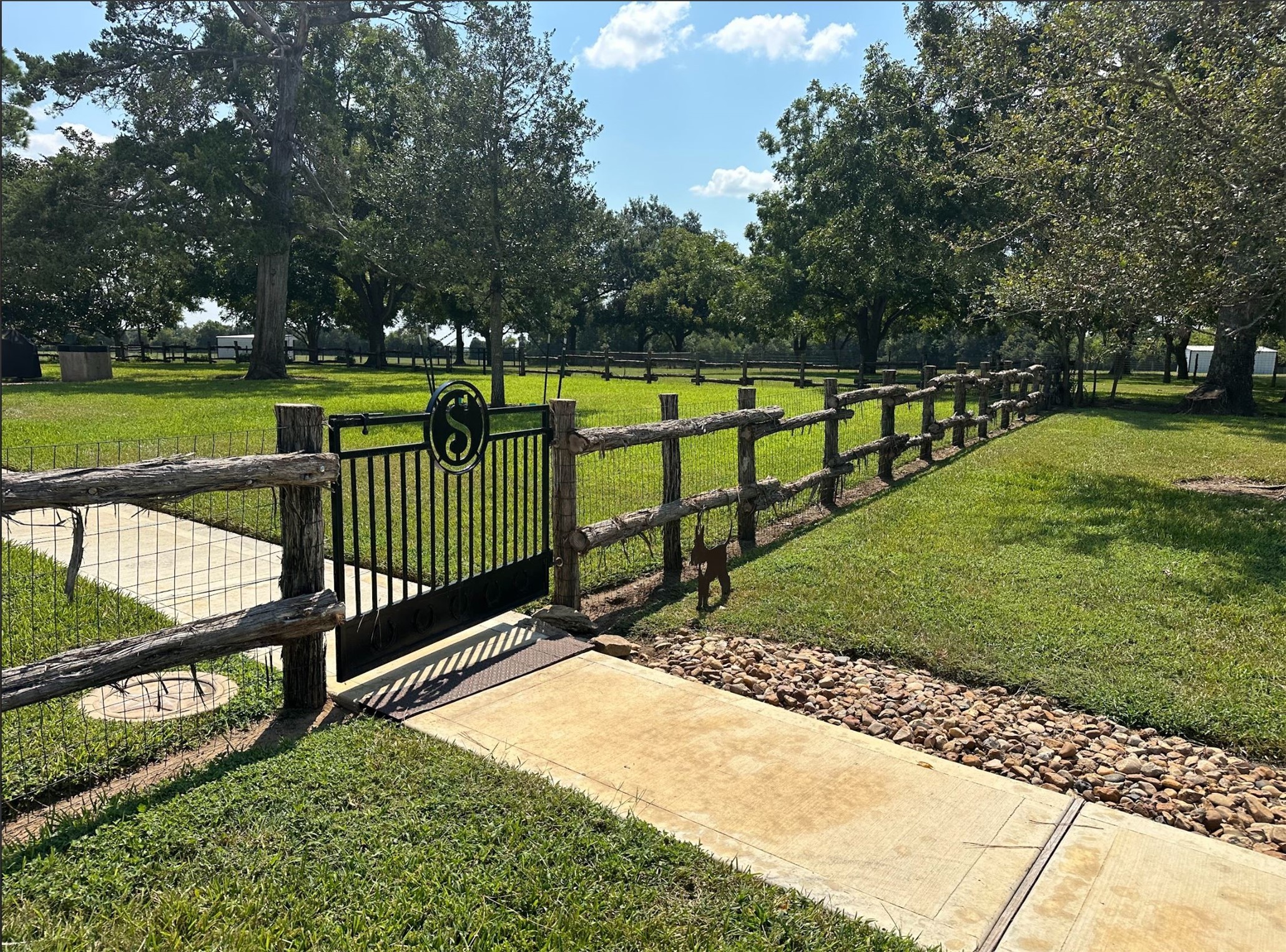 1325 Stalmach Road New Ulm, TX 78950 - Photo 33 of 50 Custom gate & fencing surround the backyard with a paved walkway.