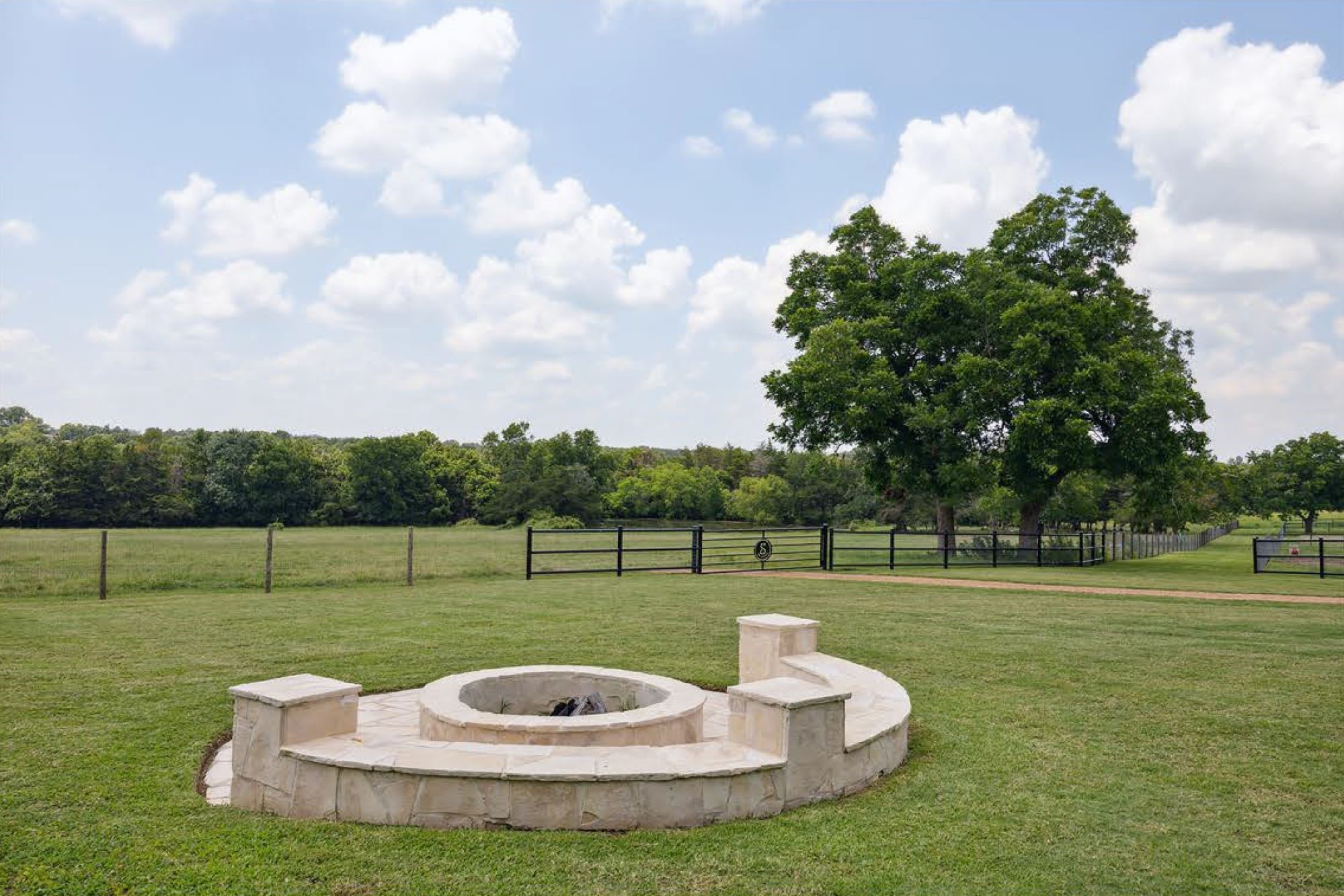 1325 Stalmach Road New Ulm, TX 78950 - Photo 36 of 50 Gorgeous stone fire pit with seating area overlooking the paddocks.