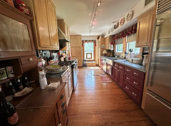 a living room with furniture a wooden floor and next to a window