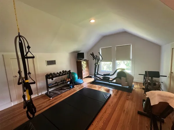 a living room with furniture a window and a piano