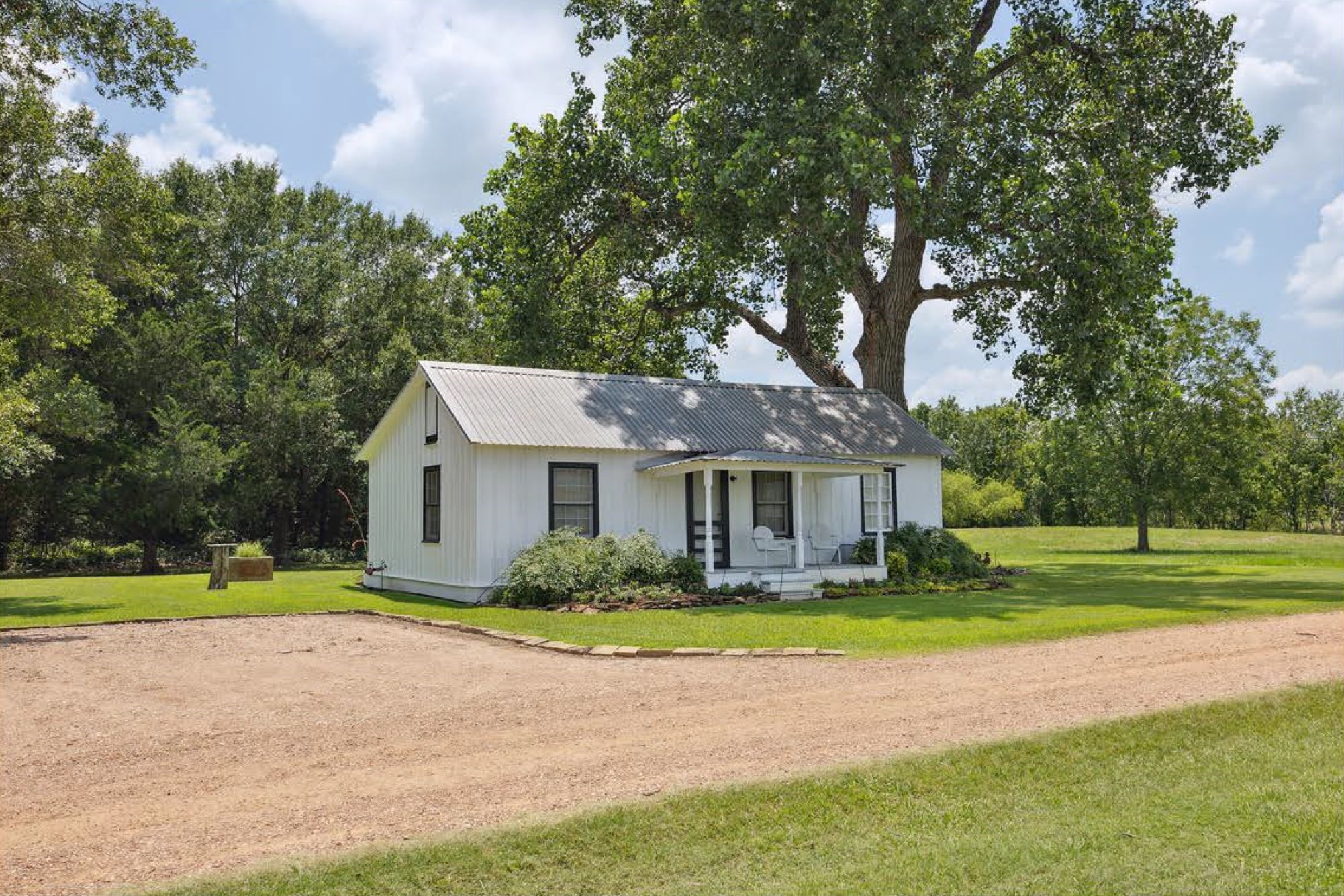 1325 Stalmach Road New Ulm, TX 78950 - Photo 48 of 50 Guest house with large gravel parking area & shaded by a huge Cottonwood tree.