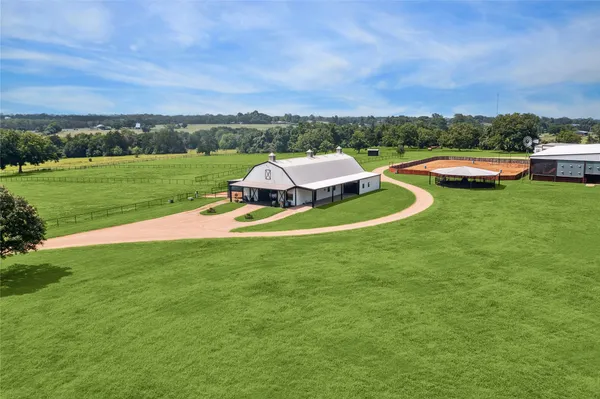 a view of a house with a big yard and lake view