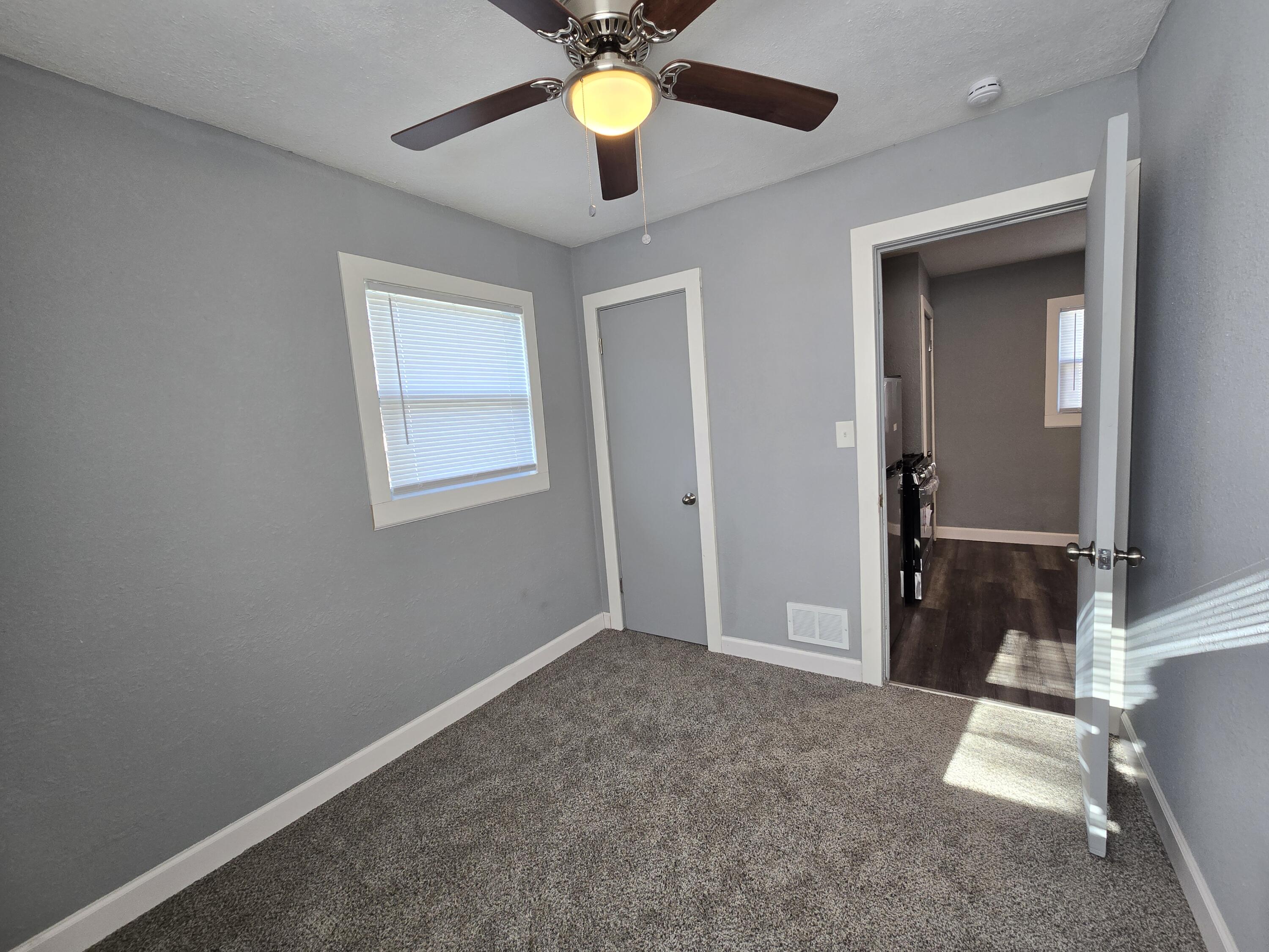 1622 Ohio Street Gary, IN 46407 - Photo 13 of 17 an empty room with closet and a chandelier fan