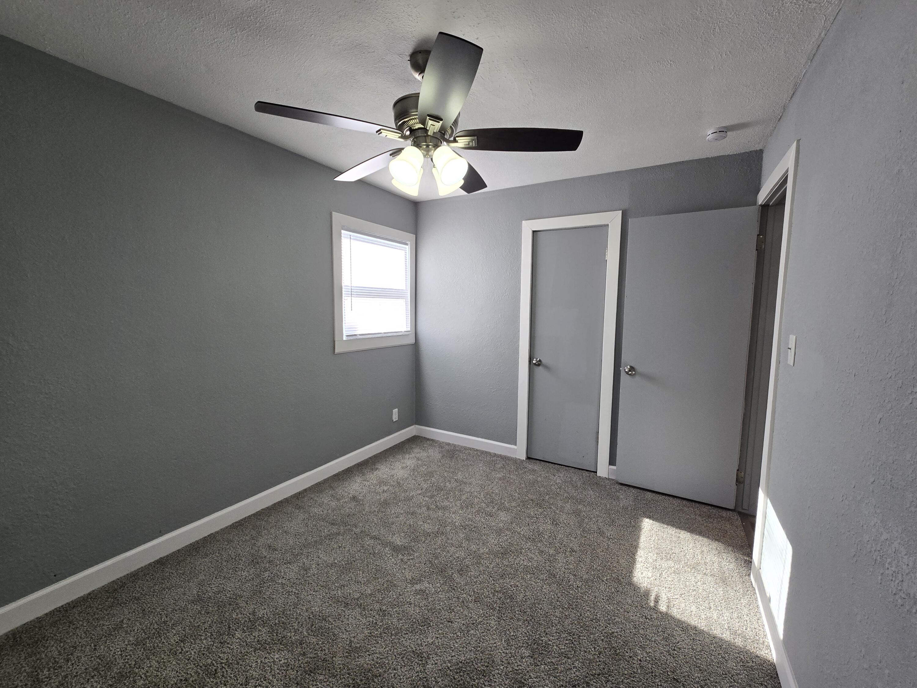 1622 Ohio Street Gary, IN 46407 - Photo 5 of 17 an empty room with windows and fan