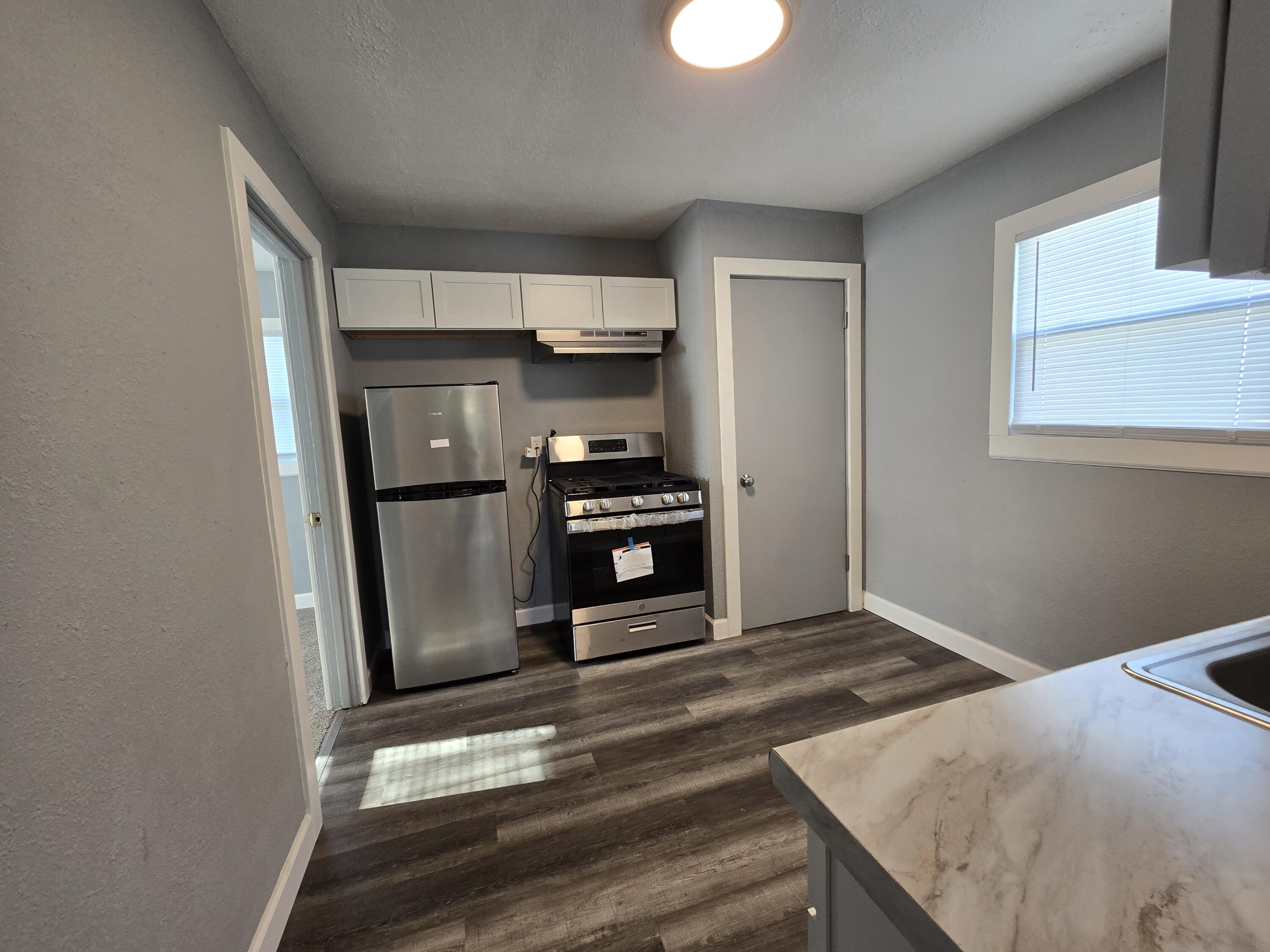 1622 Ohio Street Gary, IN 46407 - Photo 9 of 17 a kitchen with stainless steel appliances a refrigerator and a stove top oven