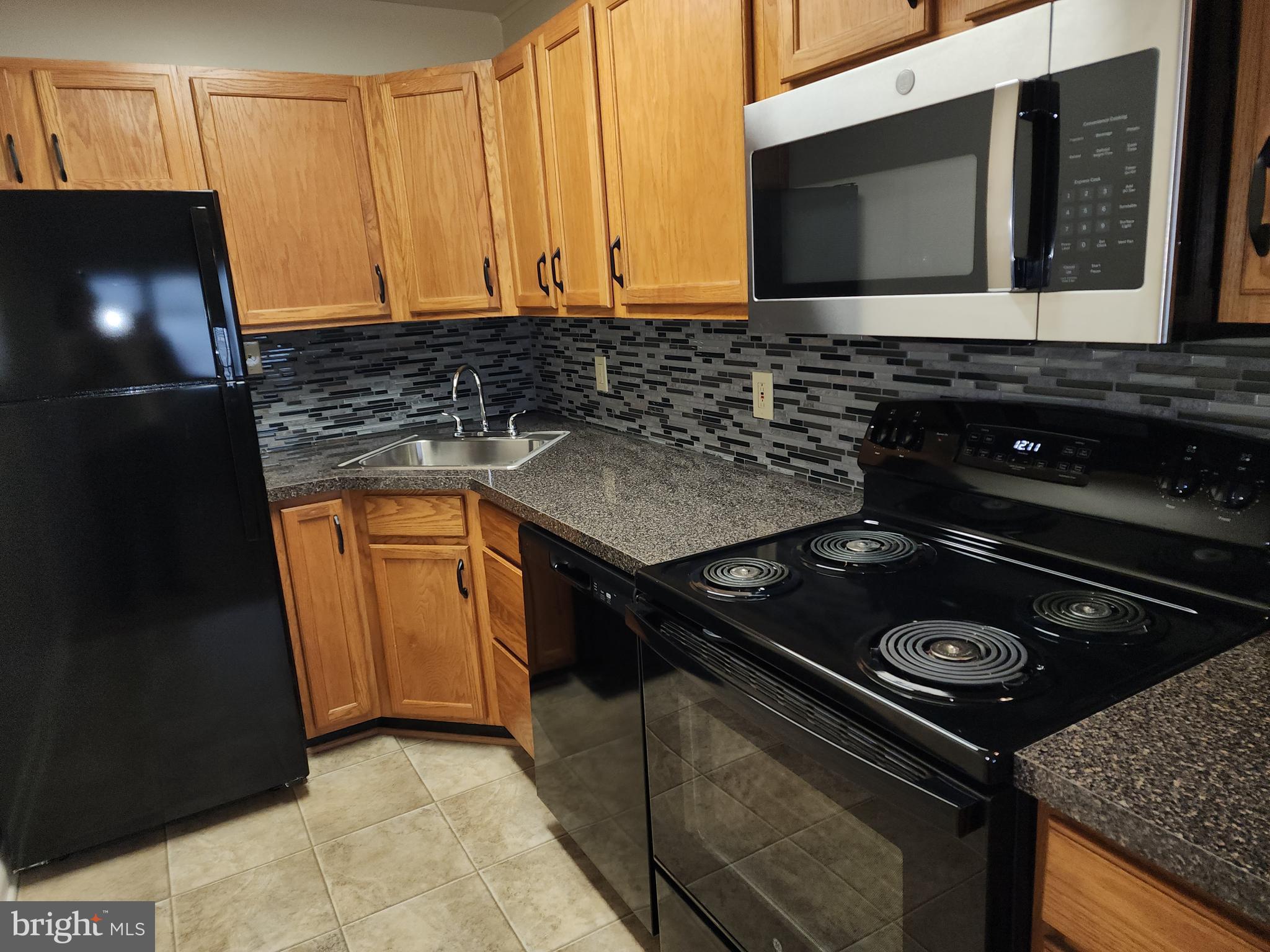 76 Lark Circle York, PA 17404 - Photo 7 of 28 a kitchen with a stove and a microwave