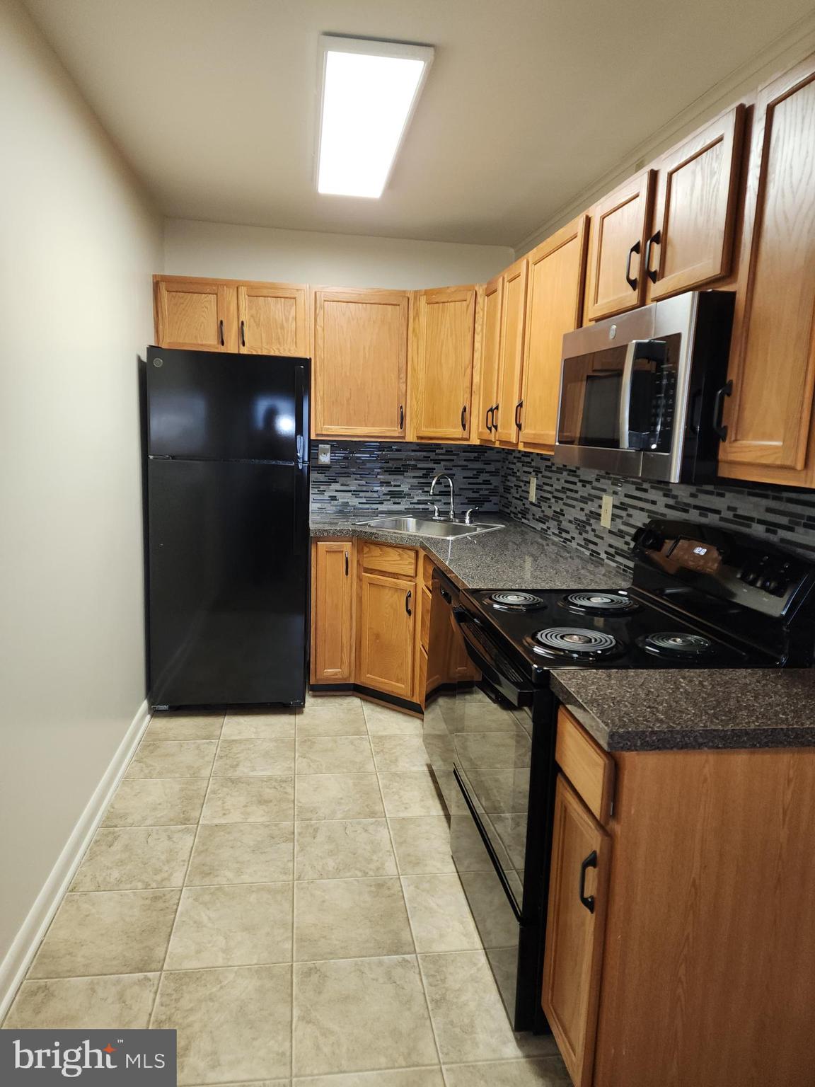 76 Lark Circle York, PA 17404 - Photo 8 of 28 a kitchen with stainless steel appliances granite countertop a stove a sink and a refrigerator
