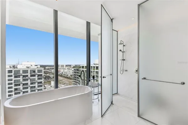 a bathroom with a bathtub and a shower