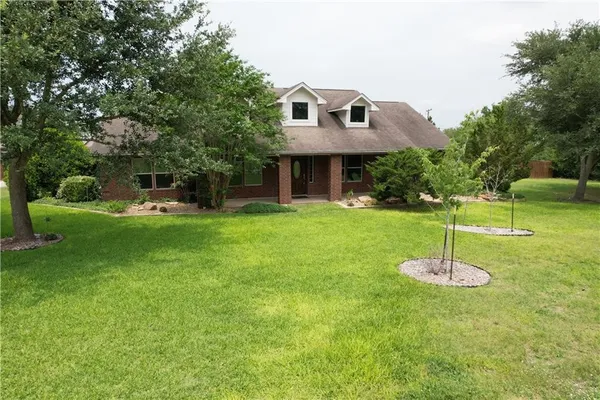 a front view of a house with a yard
