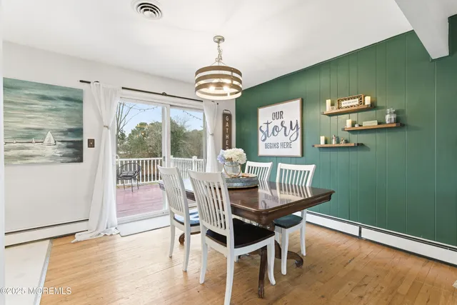 a view of a dining room with furniture wooden floor and a chandelier