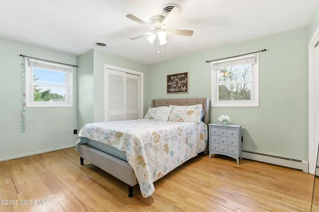 a bedroom with a bed and a painting on the wall