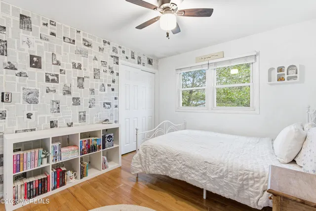 a bedroom with a bed and a book shelf