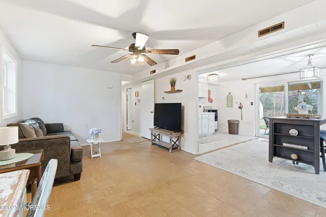 a view of a livingroom with furniture and a flat screen tv