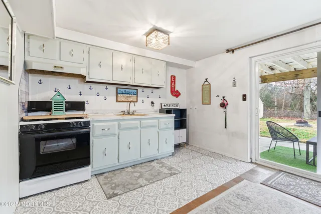 a kitchen with cabinets and window