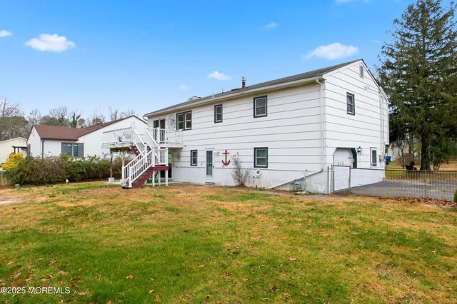 a view of a house with a yard and sitting area