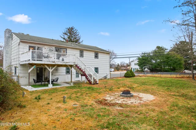a view of a house with a yard and sitting area