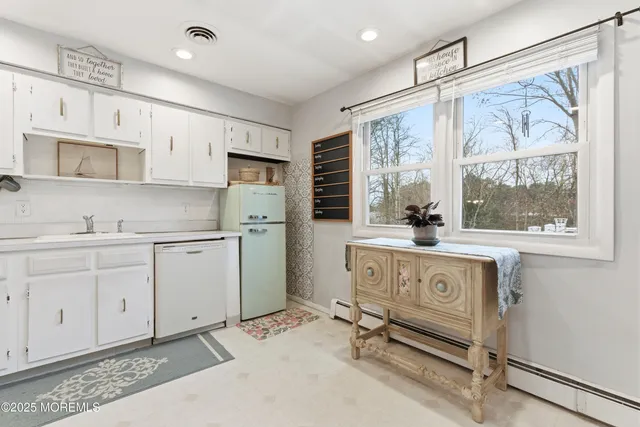 a kitchen with a refrigerator a sink and cabinets