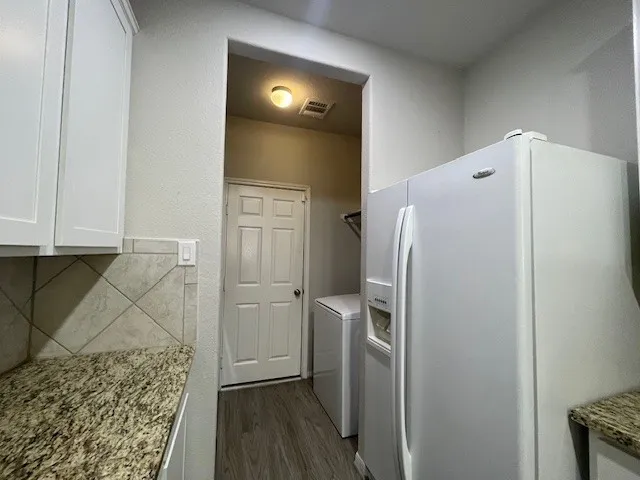 a refrigerator freezer sitting inside of a kitchen