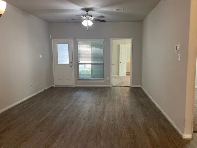 wooden floor in an empty room with a window
