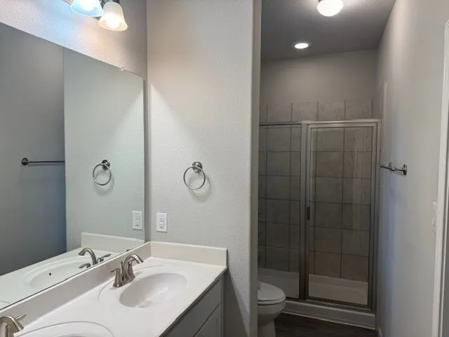 a bathroom with a sink toilet and shower