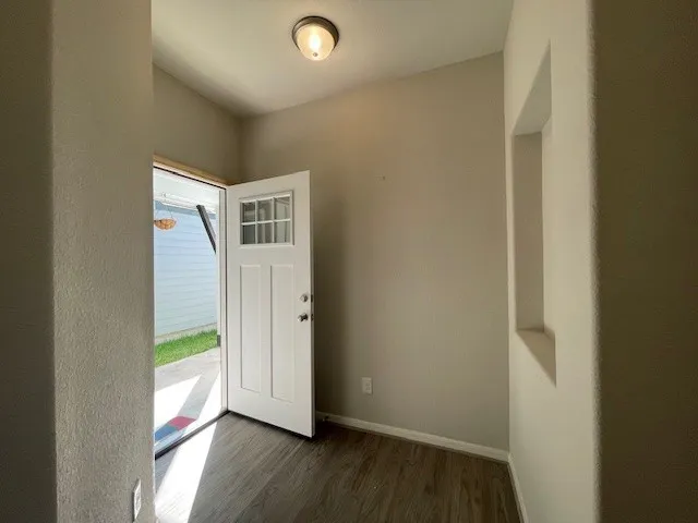 a view of front door with wooden floor