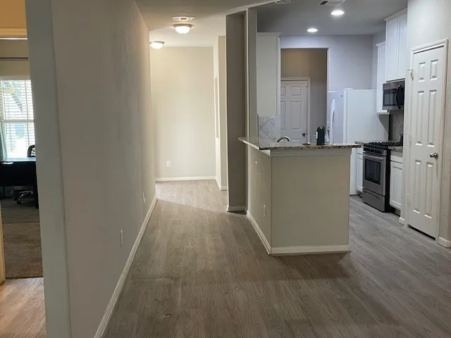 a view of a kitchen from the hallway